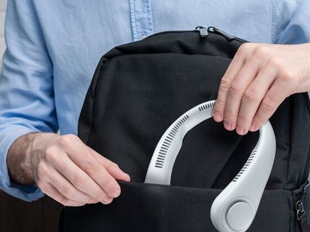 FluxoFan wearable neck fan being packed into a bag