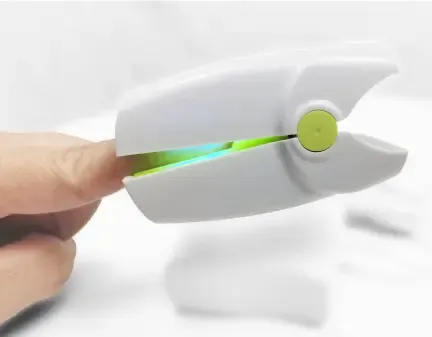 Fungus Therapy Pro clipped over a fingernail, light visible between the arms