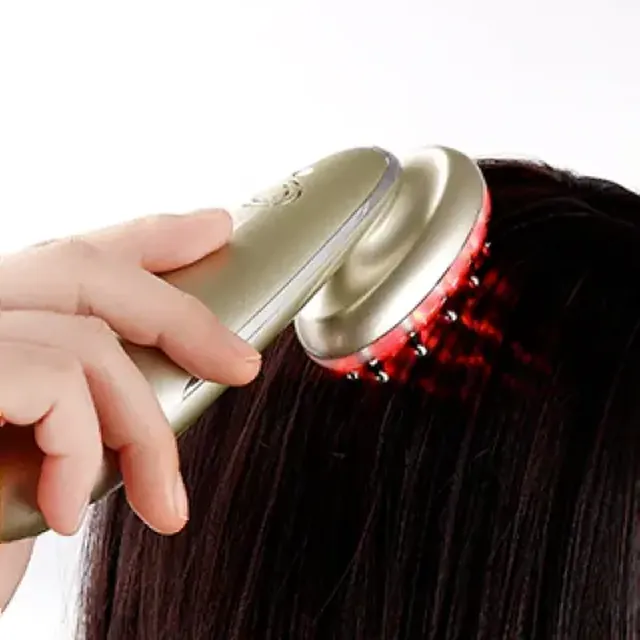 Hairpoww laser comb in use on hair